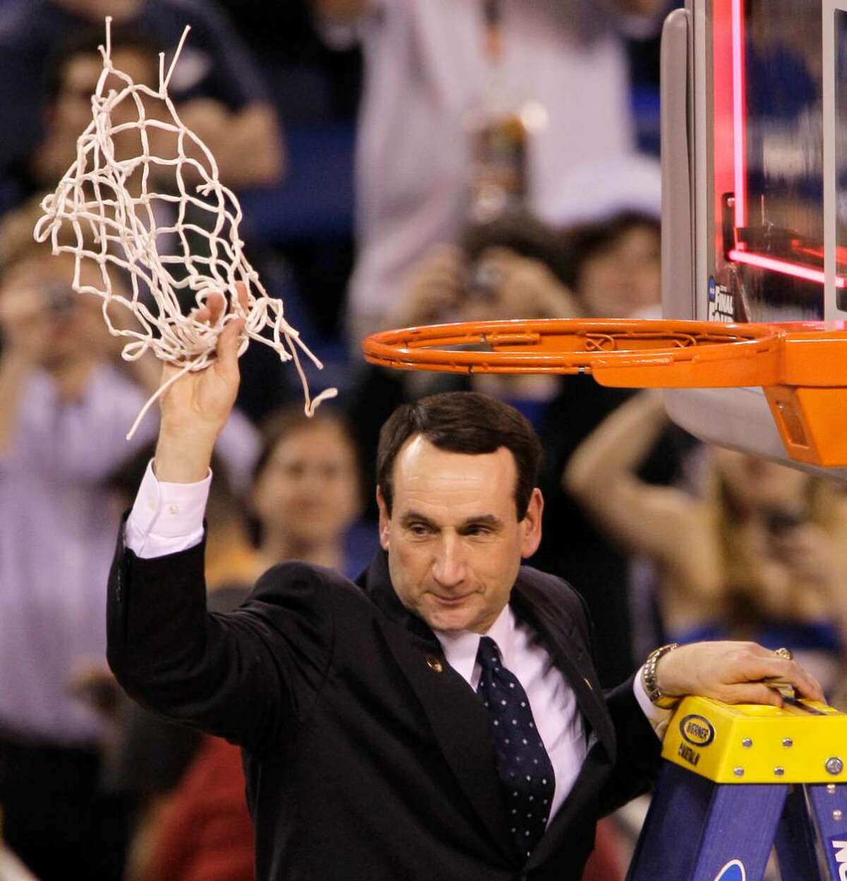 Duke head coach Mike Krzyzewski cuts down the net after Duke's 61-59 win over Butler in the men's NCAA Final Four college basketball championship game Monday, April 5, 2010, in Indianapolis.