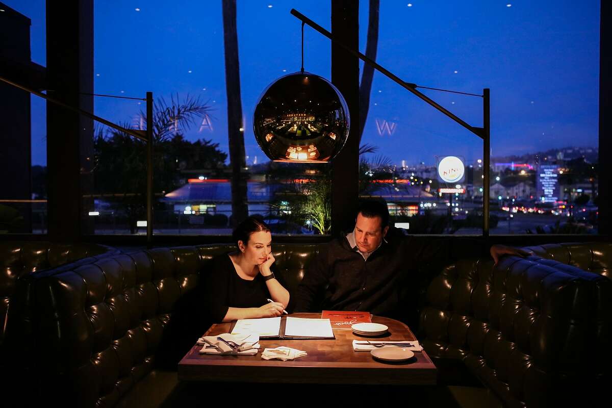 Co-owners Elena Duggan and John Duggan discuss the schedule of their grand opening at a booth in the main dining room of their family restaurant, Joe's of Westlake in Daly City, California on Tuesday, February 14, 2016.