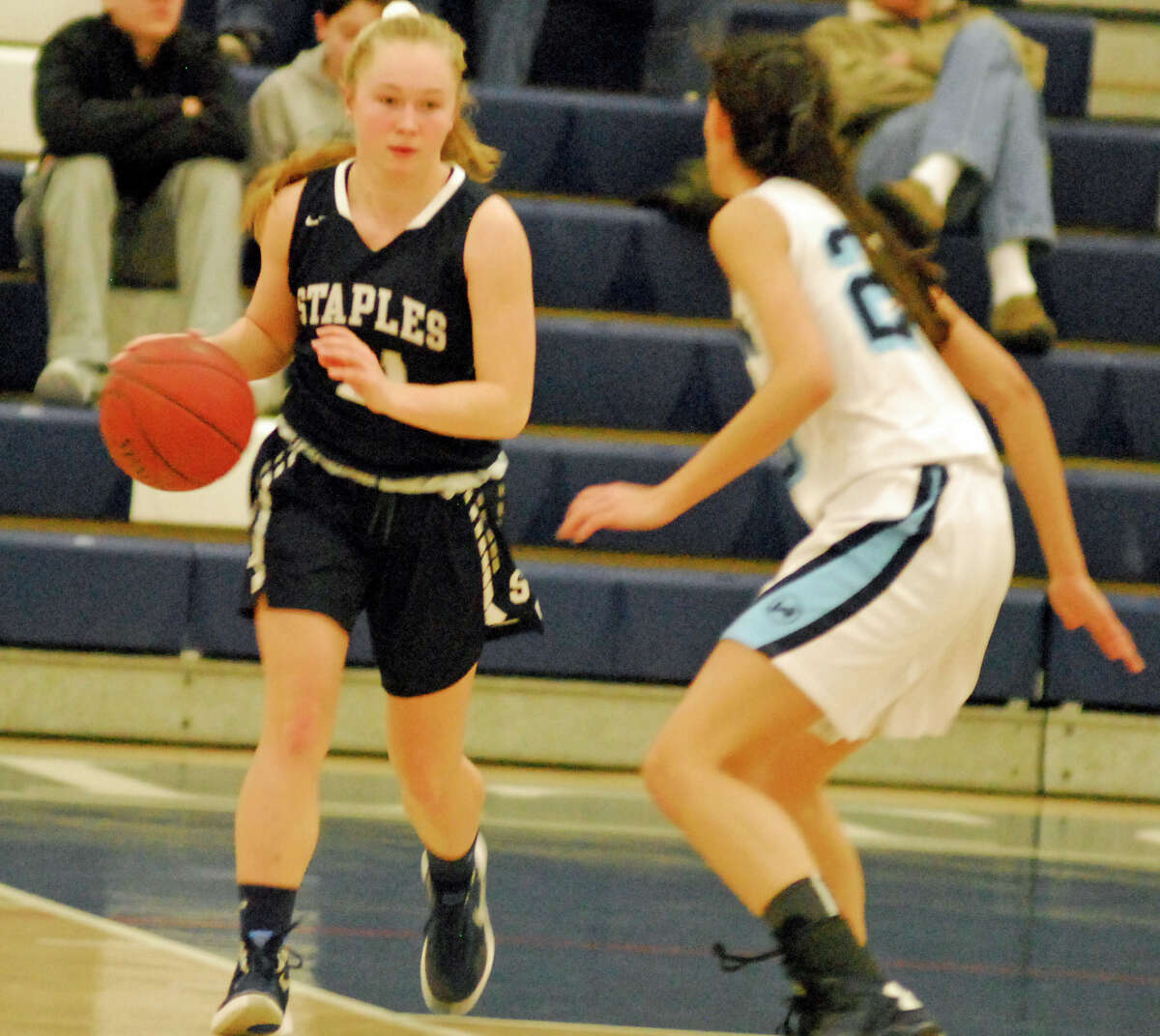 Staples' Olivia Troy dribbles up the court during a girls basketball game against Wilton on Monday, February 15th, 2016. Troy had 12 points in a 40-30 loss.
