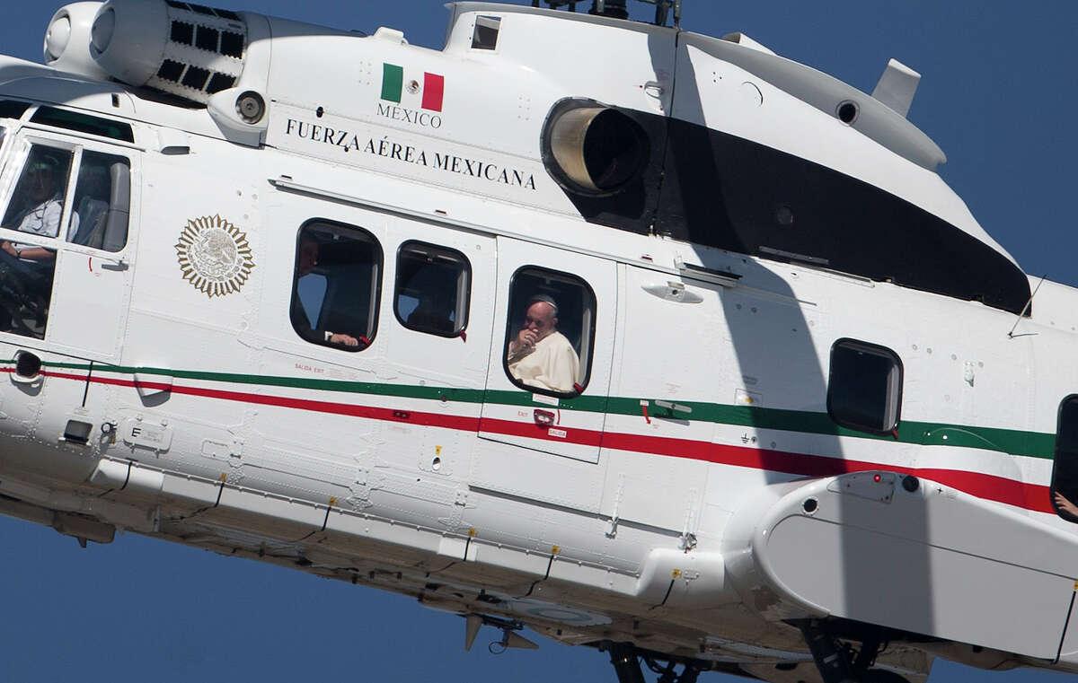 Pope Francis peers from the window of his helicopter as he arrives in San Cristobal de las Casas, Mexico, Monday, Feb. 15, 2016. Francis is celebrating Mexico's Indians on Monday with a visit to Chiapas state, a center of indigenous culture, where he will preside over a Mass in three native languages thanks to a new Vatican decree approving their use in liturgy. The visit is also aimed at boosting the faith in the least Catholic state in Mexico.