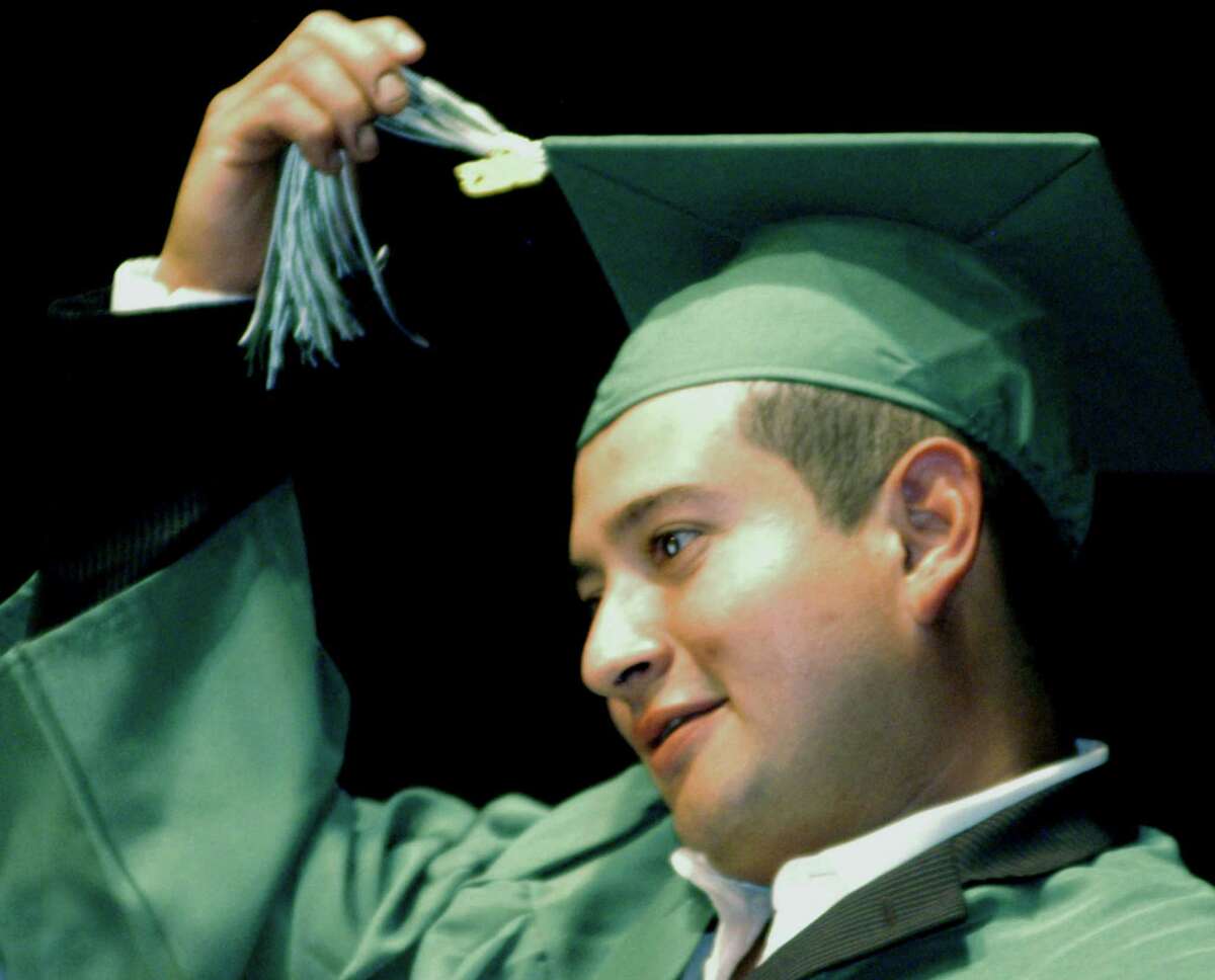 Edgardo Perez- Cabrera leads fellow New Milford High School adult- education graduates in 2013.