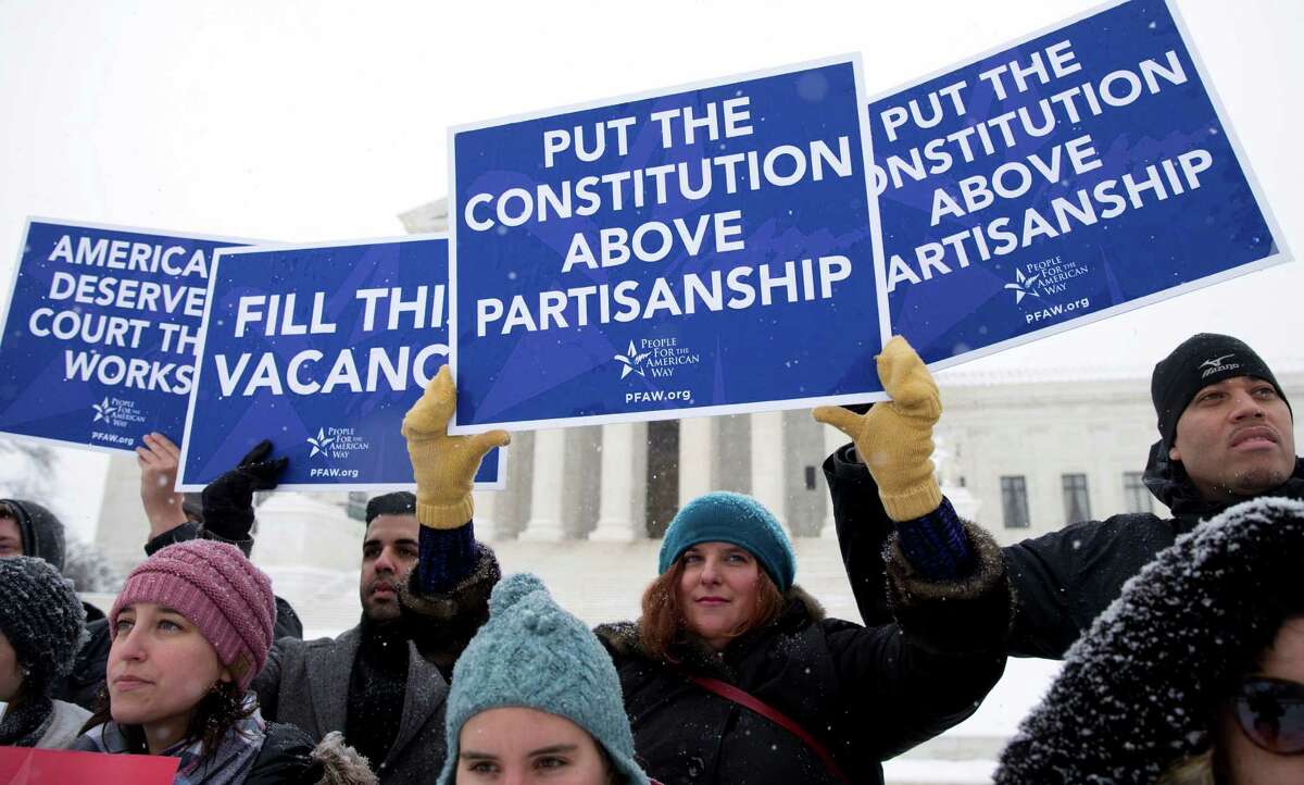 A group with "People for the American Way" from Washington, gather with signs in front of the U.S. Supreme Court in Washington, Monday, Feb. 15, 2016, as they are call for Congress to give fair consideration to any nomination put forth by President Barack Obama to fill the seat of Antonin Scalia. Scalia, the influential conservative and most provocative member of the Supreme Court, was found dead over the weekend at a private residence in the Big Bend area of West Texas. He was 79. (AP Photo/Carolyn Kaster) ORG XMIT: DCCK102