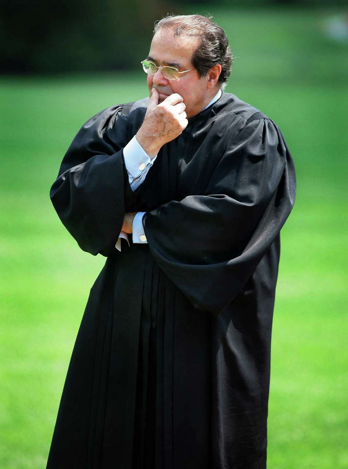 FILE - In this June 7, 2006 file photo, Supreme Court Justice Antonin Scalia listens to President Bush speak during a swearing-in ceremony on the South Lawn at the White House in Washington. On Saturday, Feb. 13, 2016, the U.S. Marshall's Service confirmed that Scalia has died at the age of 79. (AP Photo/Ron Edmonds, File)