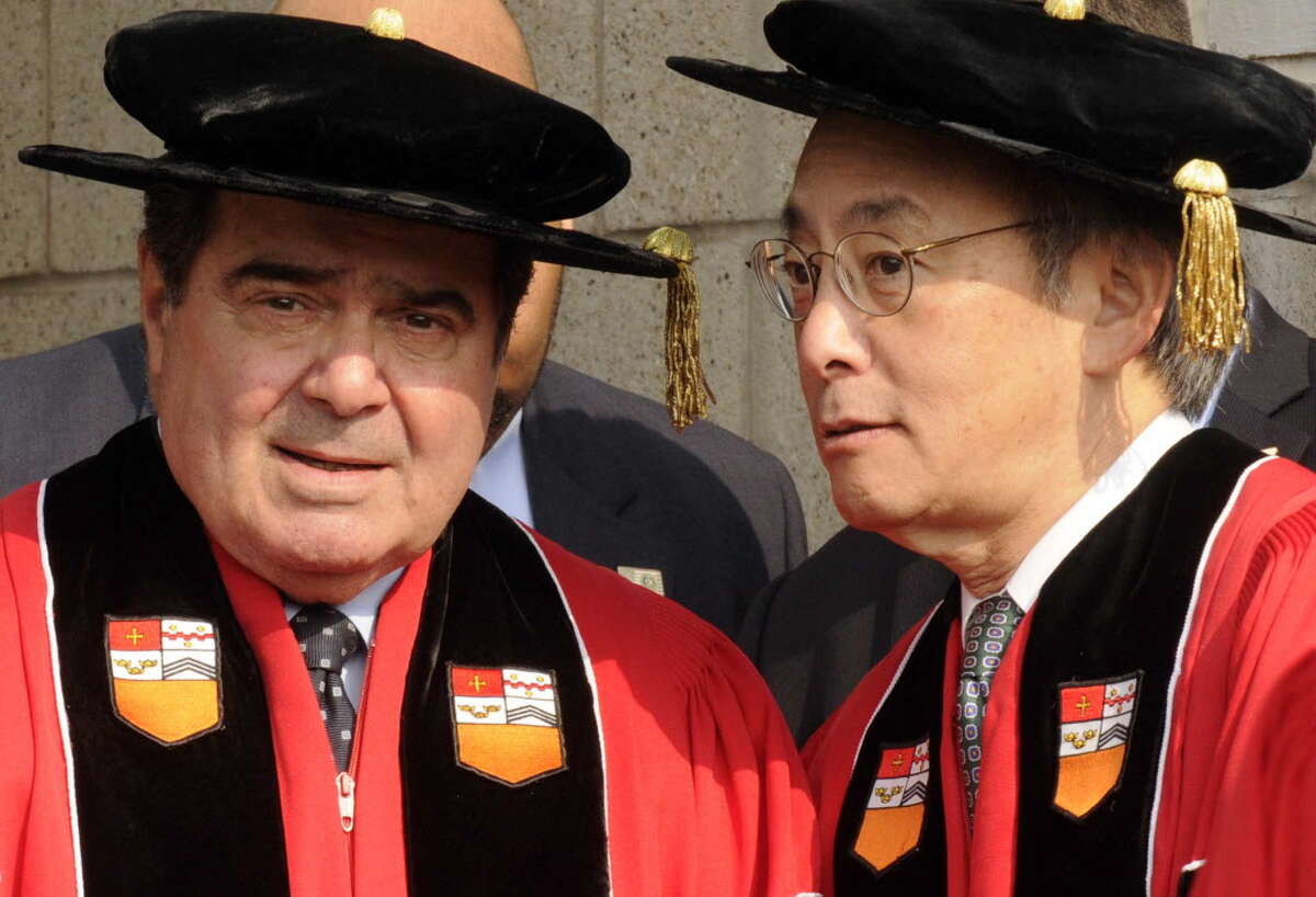 United State Secretary of Energy Steven Chu speaks with U.S. Supreme Court Justice Antonin Scalia while they walk in the processional during Rensselaer Polytechnic Institute's 206th Commencement in Troy on May 26, 2012.