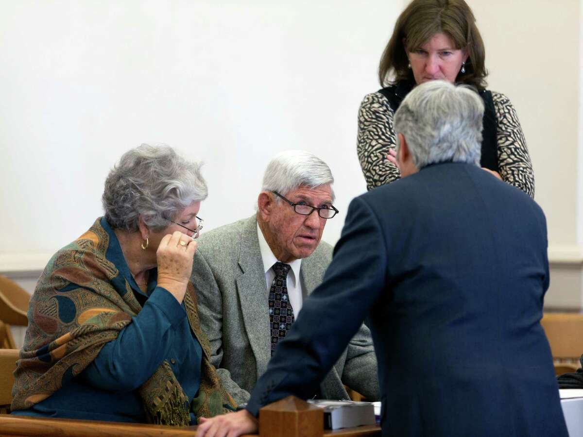 Glenn Bragg, center, his wife, JoLynn, left, and his daughter, Shelly, talk to one of their attorneys in the 38th District Court in Hondo last week. The Braggs successfully sued the Edwards Aquifer Authority, and a jury Monday awarded the family $2.5 million.
