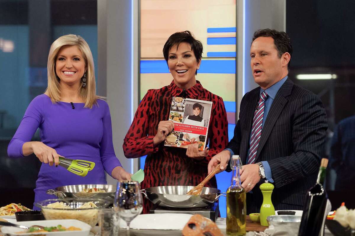Ainsley Earhardt (left) and Brian Kilmeade interview Kris Jenner during her visit to "FOX And Friends" at FOX Studios on October 21, 2014 in New York City.