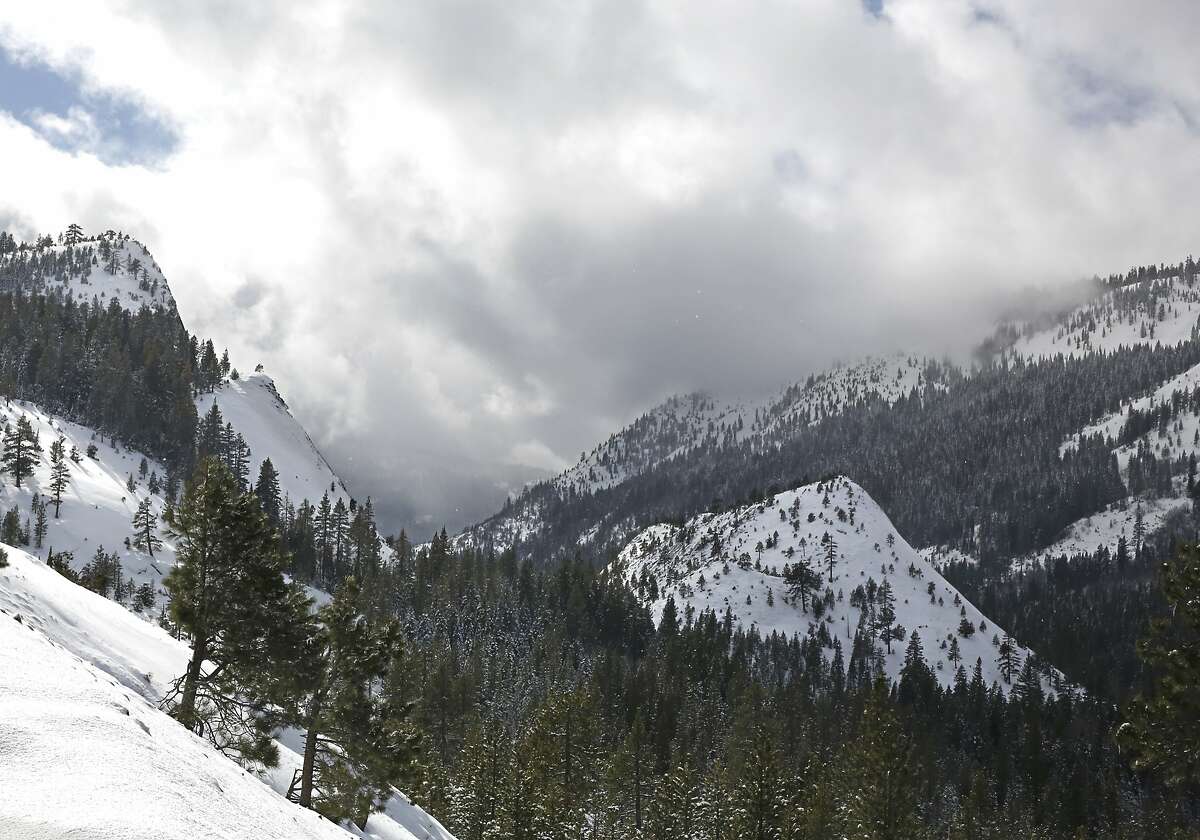 The sun beaks through the clouds over the snow covered Sierra Nevada near Echo Summit, Calif., Tuesday, Feb. 2, 2016. The California Department of Water Resources held it's second manual snow survey of the season, Tuesday, which showed the snowpack at 130 percent of normal at the Phillips Station near Echo Summit.