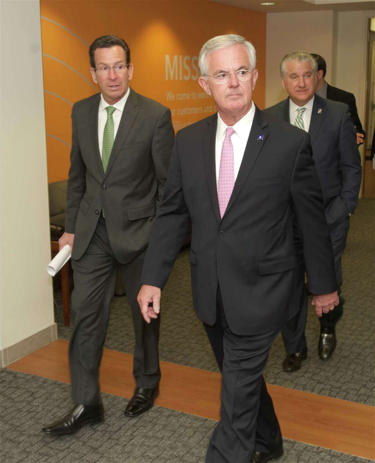 Connecticut Gov. Dannel P. Malloy walks with Cartus CEO Kevin Kelleher in the company's Danbury, Conn. headquarters in April 2014.