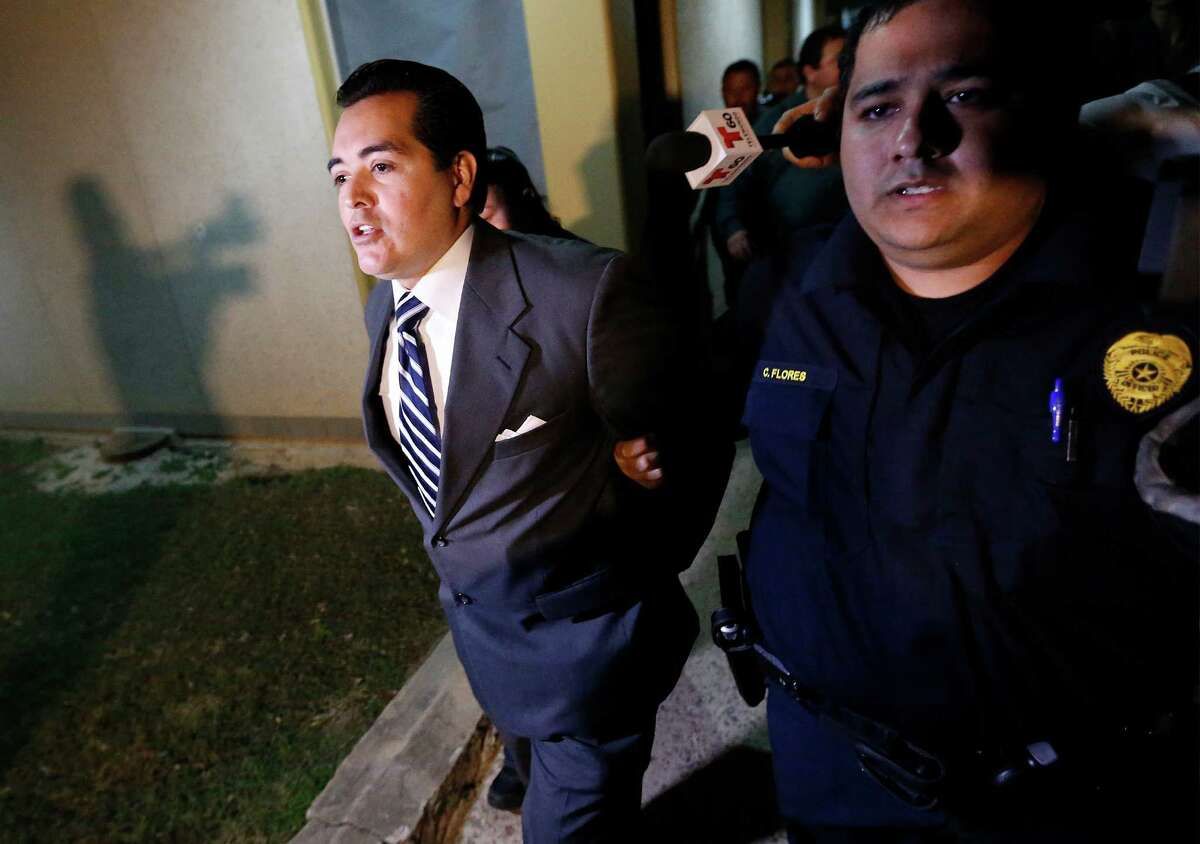 Crystal City Mayor Ricardo Lopez is taken away from city hall by police after a scuffle with citizens during a heated council meeting to suspend city manager James Jonas III and to force a recall election after Jonas and three city council members were faced federal corruption charges on Tuesday, Feb. 16, 2016. (Kin Man Hui/San Antonio Express-News)