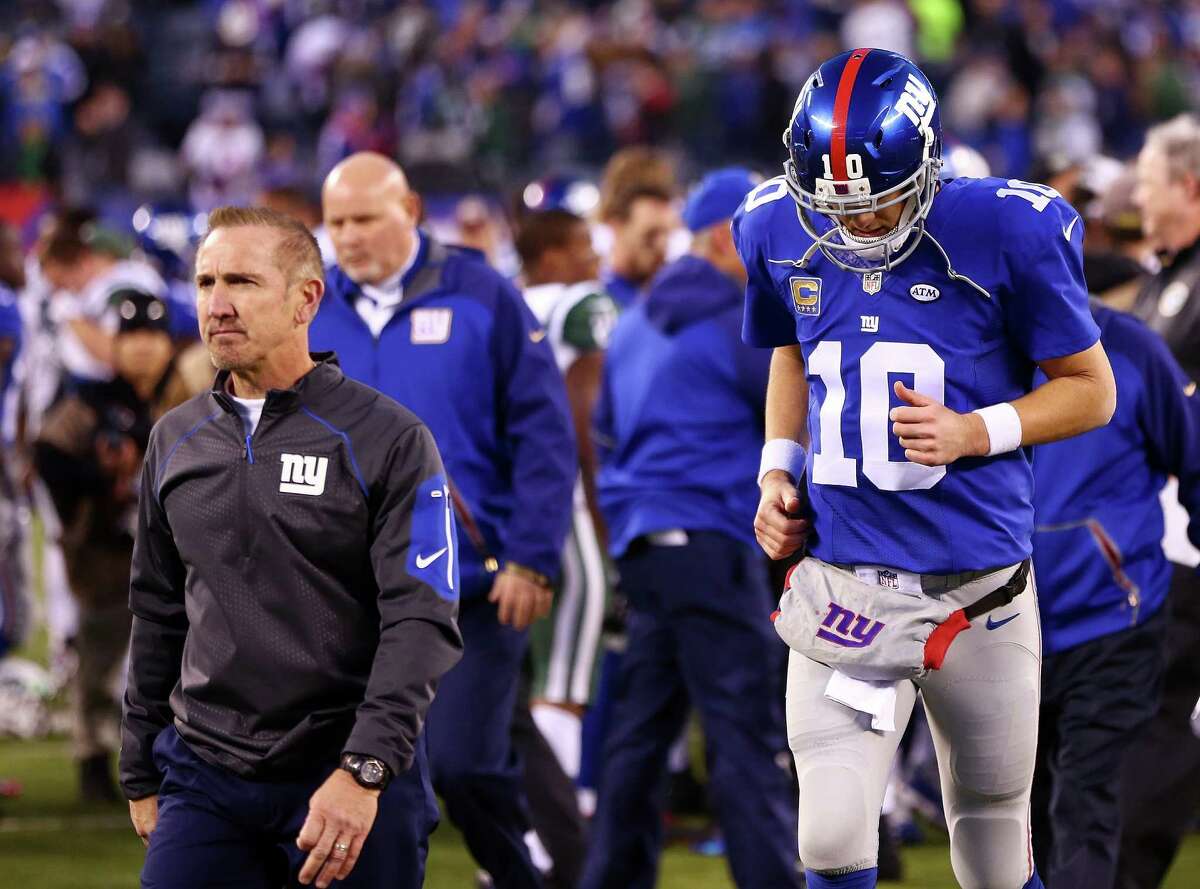EAST RUTHERFORD, NJ - DECEMBER 06: Defensive coordinator, Steve Spagnuolo and Eli Manning #10 of the New York Giants reacts after losing to the New York Jets by a score of 23-20 at MetLife Stadium on December 6, 2015 in East Rutherford, New Jersey. (Photo by Michael Heiman/Getty Images) ORG XMIT: 587435561
