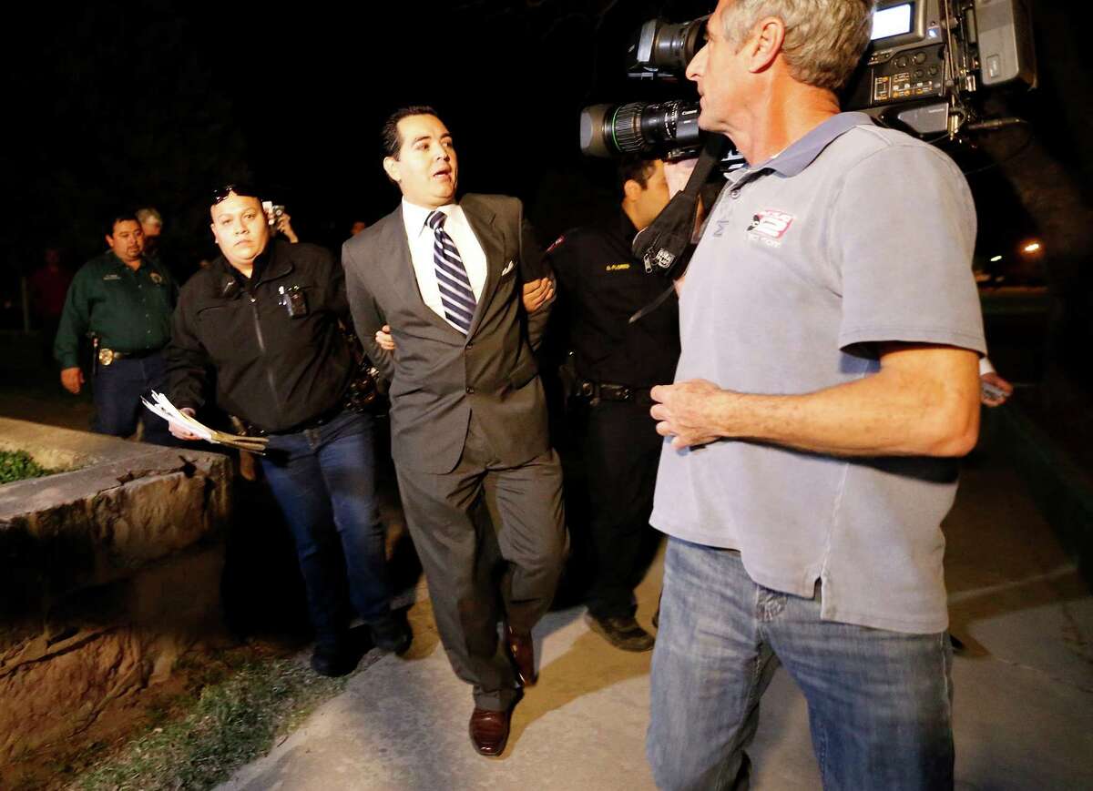 Crystal City Mayor Ricardo Lopez is taken away from city hall by police after a scuffle with citizens during a heated council meeting to suspend city manager James Jonas III and to force a recall election after Jonas and three city council members were faced federal corruption charges on Tuesday, Feb. 16, 2016. (Kin Man Hui/San Antonio Express-News)