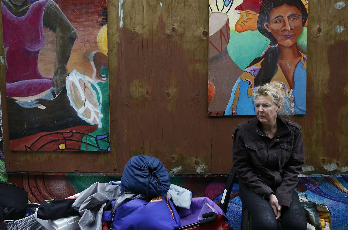 Kristin Vanscoy sits on her stuff while preparing to move after she and others who have been living along the sidewalk for months said that the police told them to move from their spot along Division Street Feb. 17, 2016 in San Francisco, Calif.