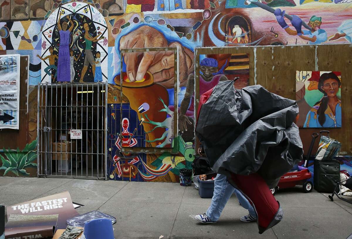 Archie Williams packs up a tent after he and others who have been living along the sidewalk said that the police told them to move from their spot along Division Street Feb. 17, 2016 in San Francisco, Calif.