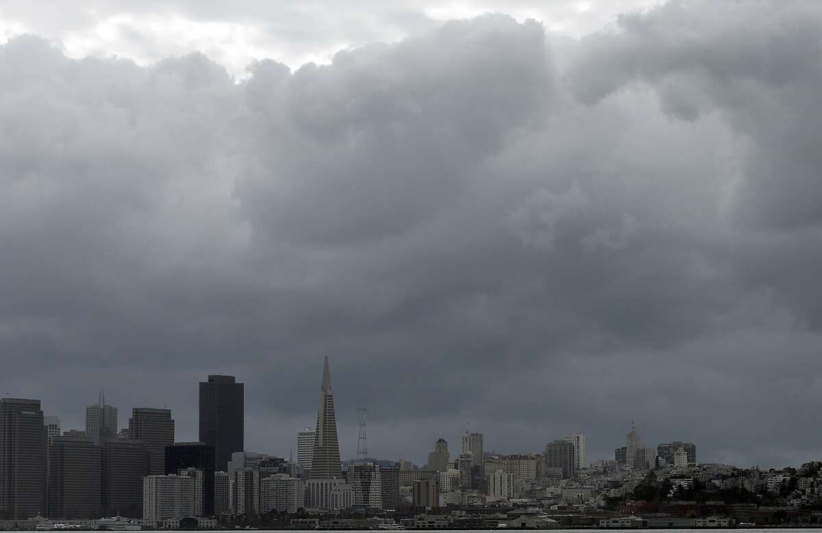 Storm clouds move over the San Francisco skyline Wednesday, Feb. 17, 2016. After three days of record-breaking heat, a cold front from Oregon brought high winds and rain to Northern California, Wednesday with strong gusts in the San Francisco Bay Area. (AP Photo/Ben Margot)