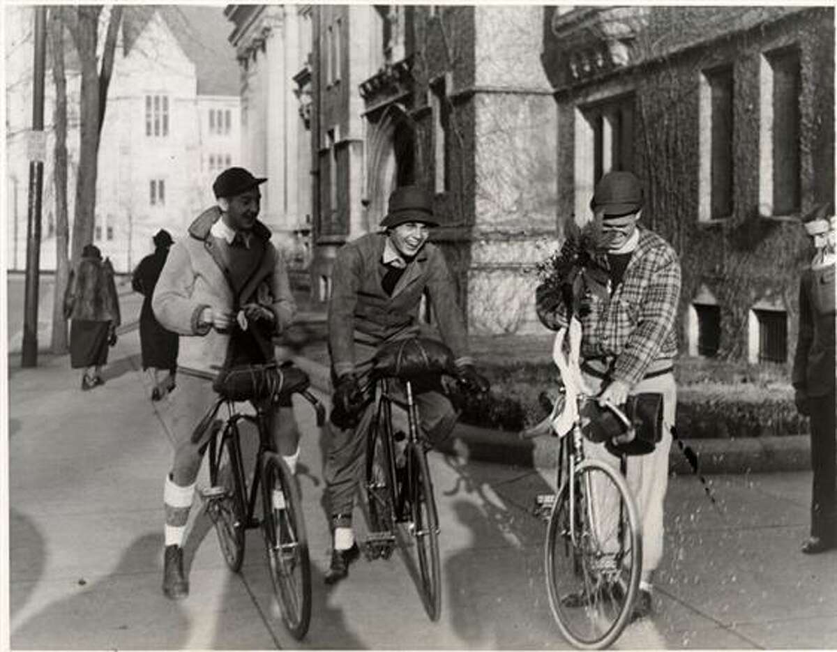 Three students bicycling.