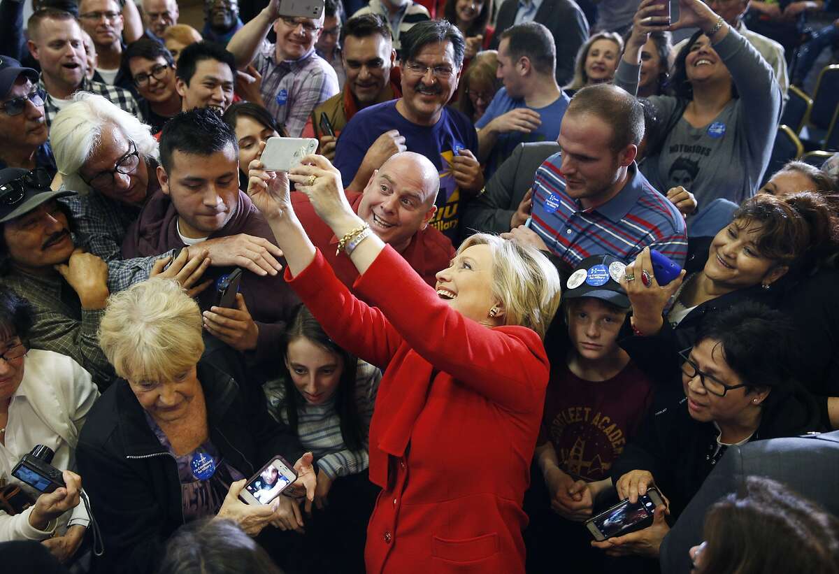 Democratic presidential candidate Hillary Clinton takes a selfie with supporters during a rally Sunday, Feb. 14, 2016, in Las Vegas. (AP Photo/John Locher)