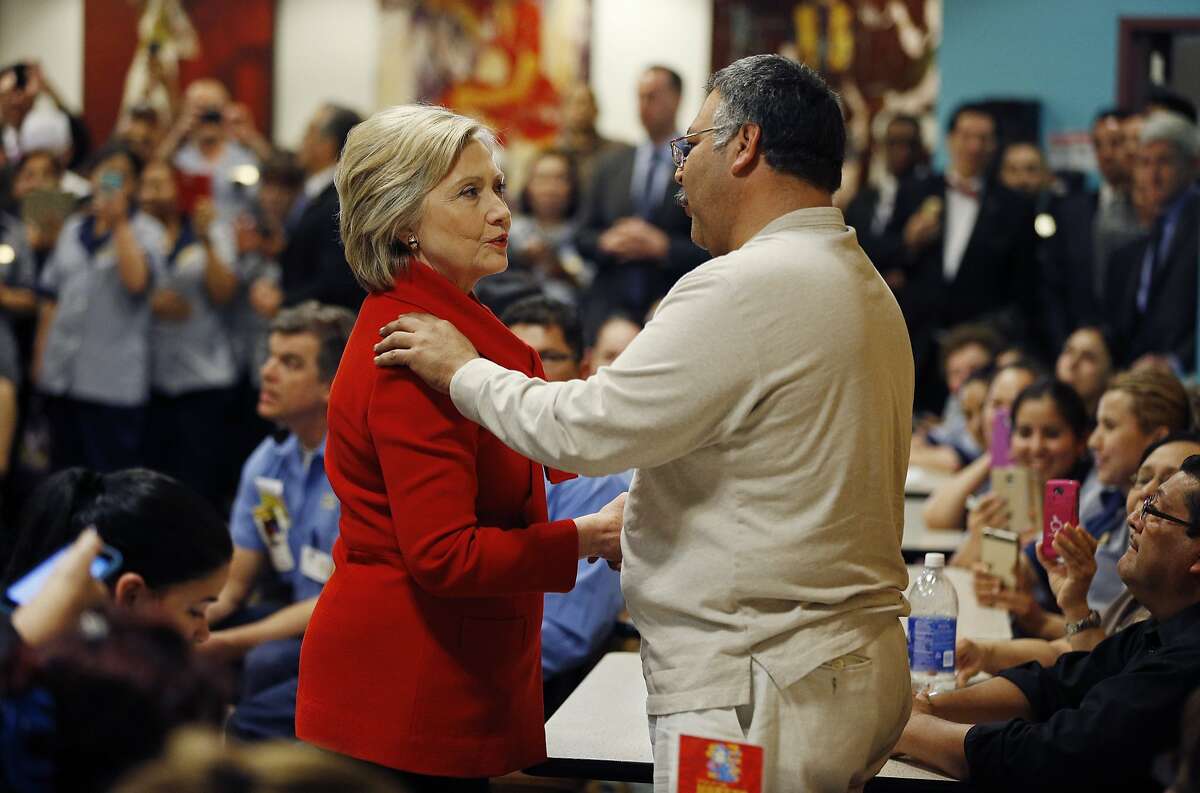 Democratic presidential candidate Hillary Clinton speaks with an employee of Caesars Palace during a visit to the casino Sunday, Feb. 14, 2016, in Las Vegas. (AP Photo/John Locher)