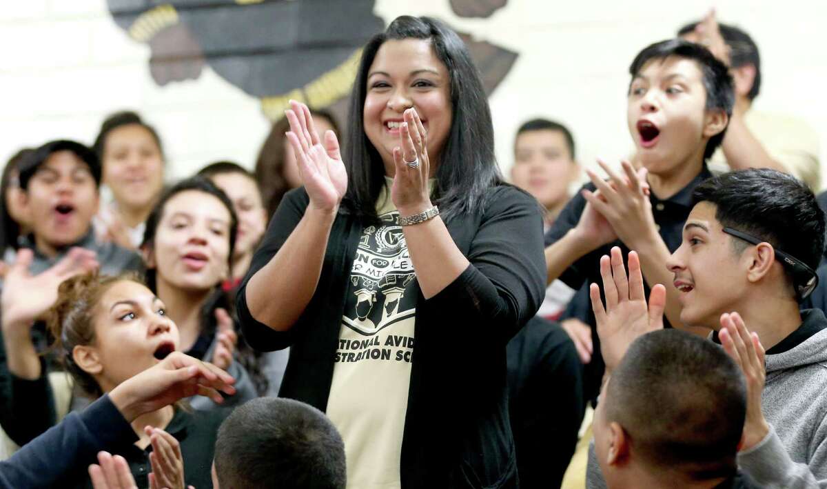 Whittier Middle School math teacher Laura Servin stands Thursday morning Feb. 18, 2016 as her students react to her receiving the Milken Education Award. The only teacher in Texas to receive the award this year, Servin receives a $25,000 award she is allowed to spend as she wants, according to the Milken Family Foundation which administers the prize.