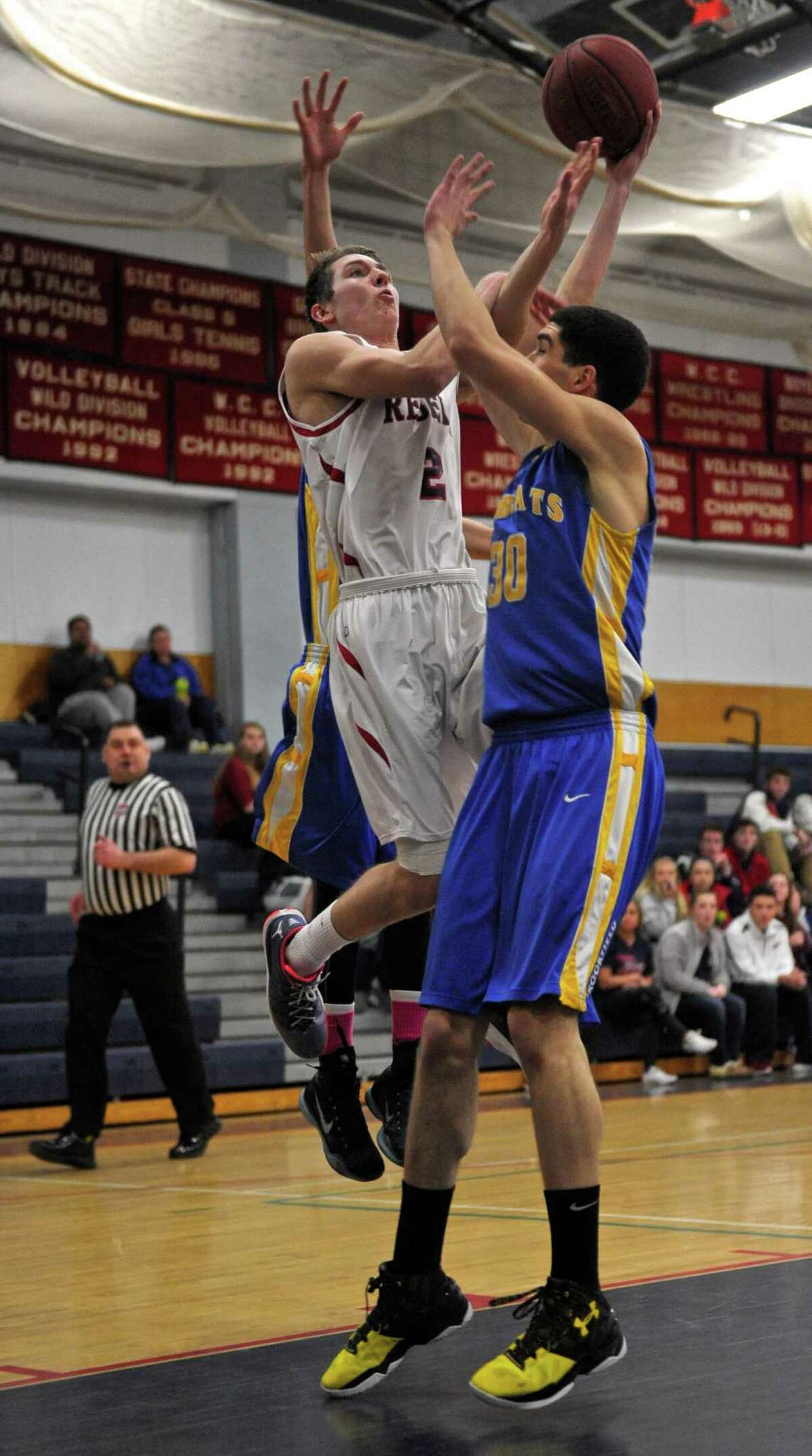 New Fairfield’s Joe Valenti drives to the basket against Brookfield’s Nick Lopez during the Rebels’ 56-53 victory on Thursday at New Fairfield.