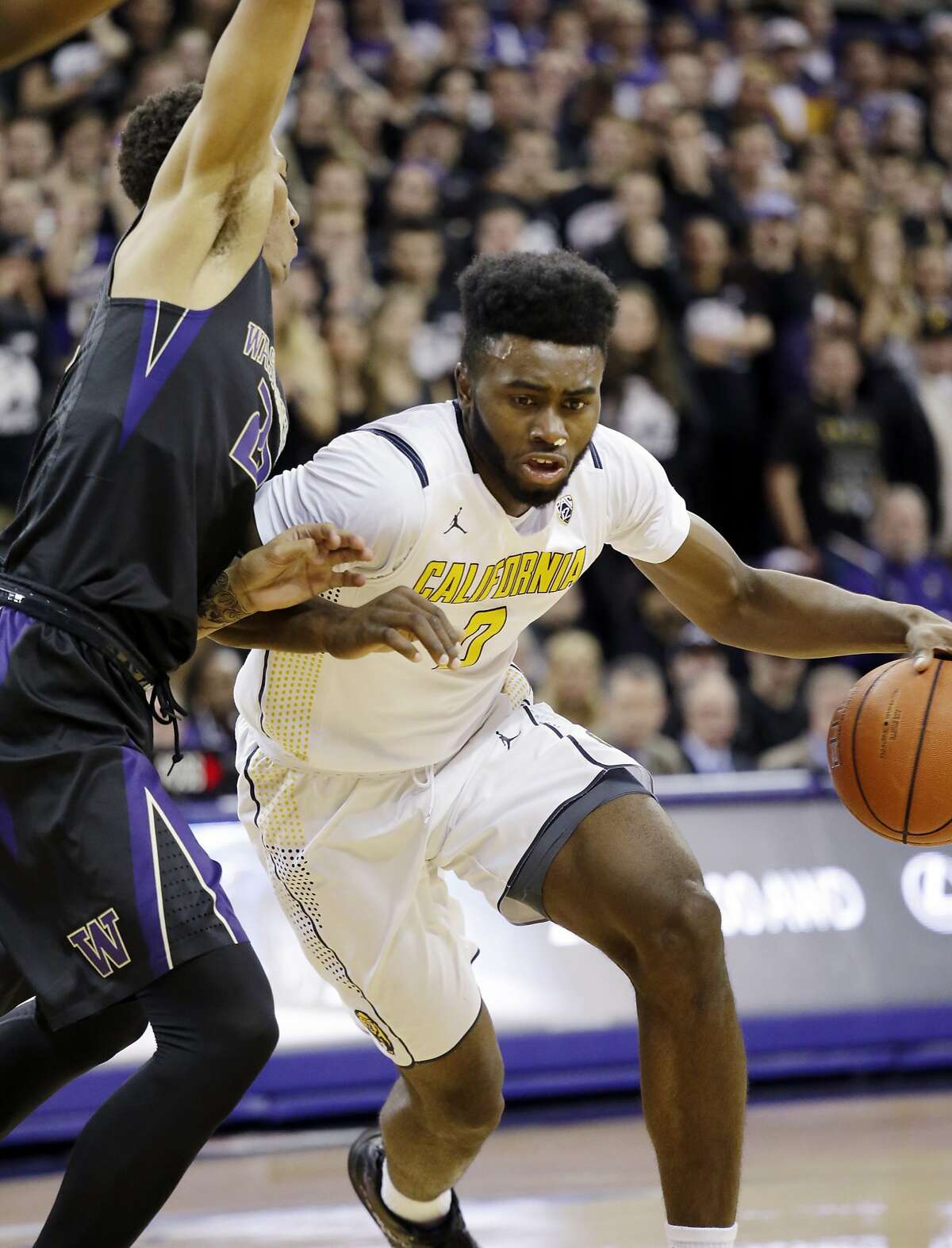 California's Jaylen Brown (0) tries to drive past Washington's Dominic Green during the first half of an NCAA college basketball game Thursday, Feb. 18, 2016, in Seattle. (AP Photo/Elaine Thompson)