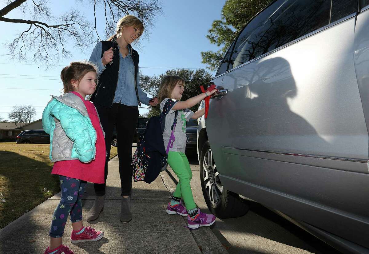 Jennifer Gerry, with daughter Marion, 3, picks up daughter Addison, 6, from highly rated Briargrove Elementary School. ﻿