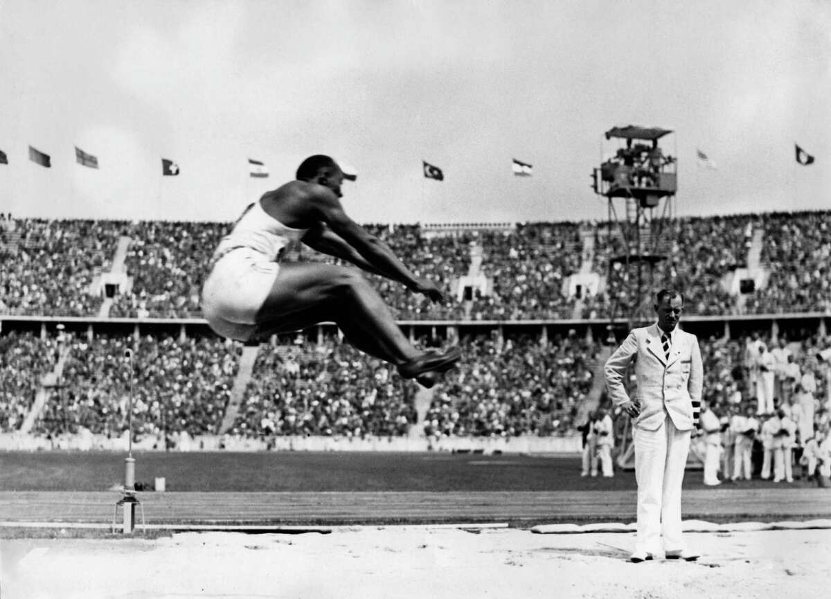 Historic photos show Jesse Owens smashing world records at Hitler's