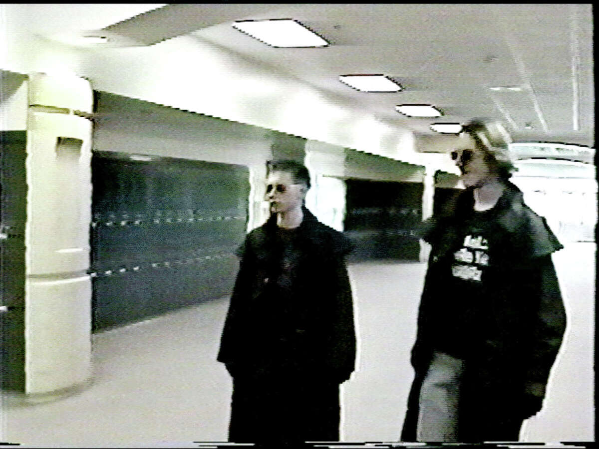 Eric Harris, left, and Dylan Klebold, students involved in the killings at Columbine High School, are shown in this image made from video released by the Jefferson County Sheriff's Department on Feb. 26, 2004, as they walked the hallway at Columbine High Schoo﻿l.