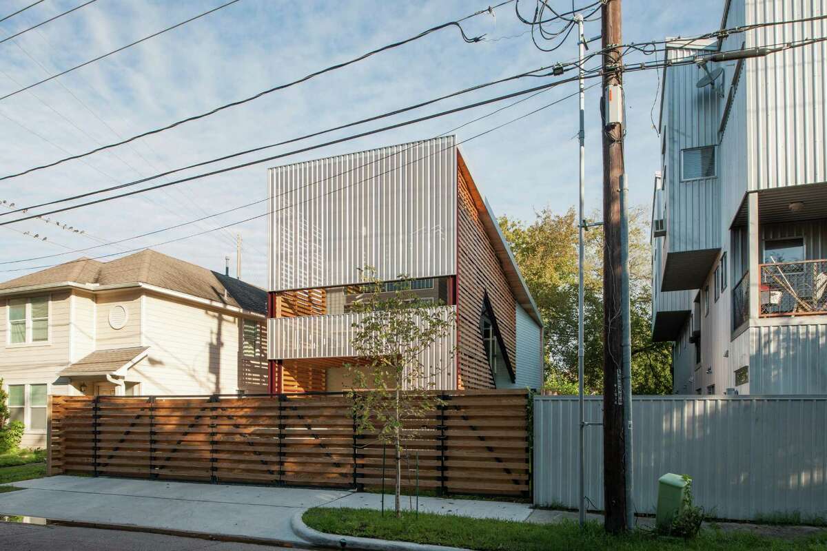 Zui Ng built his "Shotgun Chameleon" house on a narrow block in the Fourth Ward. Wooden slats and perforated stainless steel offer privacy and give the front of the house a distinctive look.