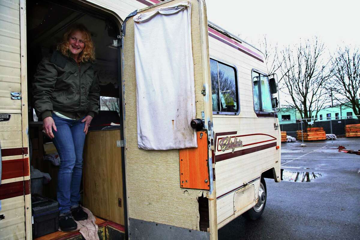 Wanda Wiliams smiles out from her RV after it was the first vehicle moved to a new "safe lot" at Shilshole Avenue and 24th Avenue NW in Ballard, Friday, Feb. 19, 2016. Williams has been homeless for the past three years and is excited to have a spot in the new lot. A second lot was planned for Delridge, but the scrapped after the city realized it was paying roughly $1,750 per vehicle per month to house the RVs in Ballard.