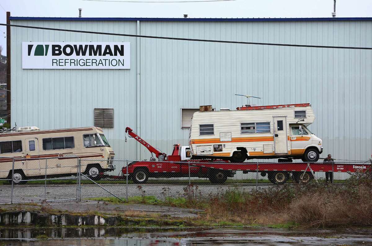 Workers from Ken's Towing move RVs from a temporary lot at 14th Avenue NW and NW 46th Street to a new "safe lot" at Shilshole Avenue and 24th Avenue NW in Ballard, Friday, Feb. 19, 2016. A second "safe lot" location will open in Deldrige in two weeks.