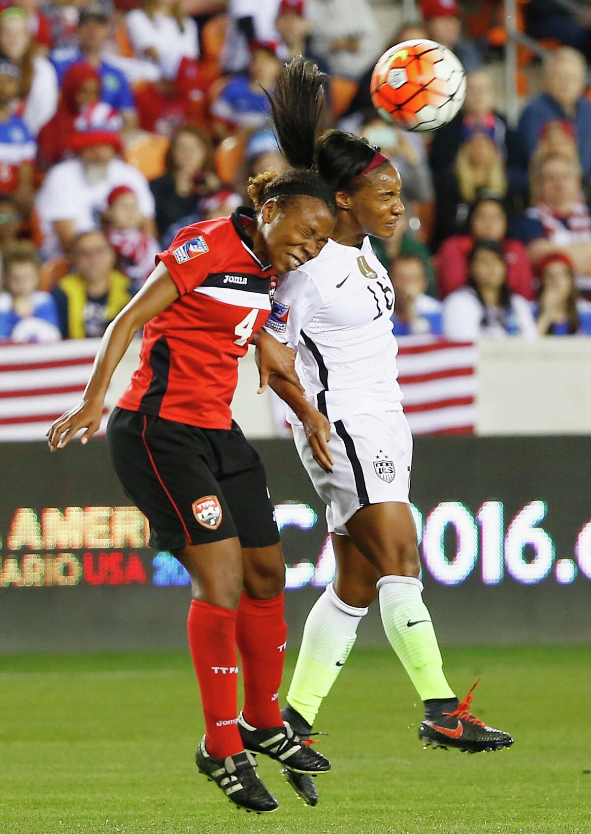 HOUSTON, TX - FEBRUARY 19: Crystal Dunn #16 of the United States battles for the ball with Danielle Blair #4 of Trinidad and Tobago during their Semifinal of the 2016 CONCACAF Women's Olympic Qualifying at BBVA Compass Stadium on February 19, 2016 in Houston, Texas.