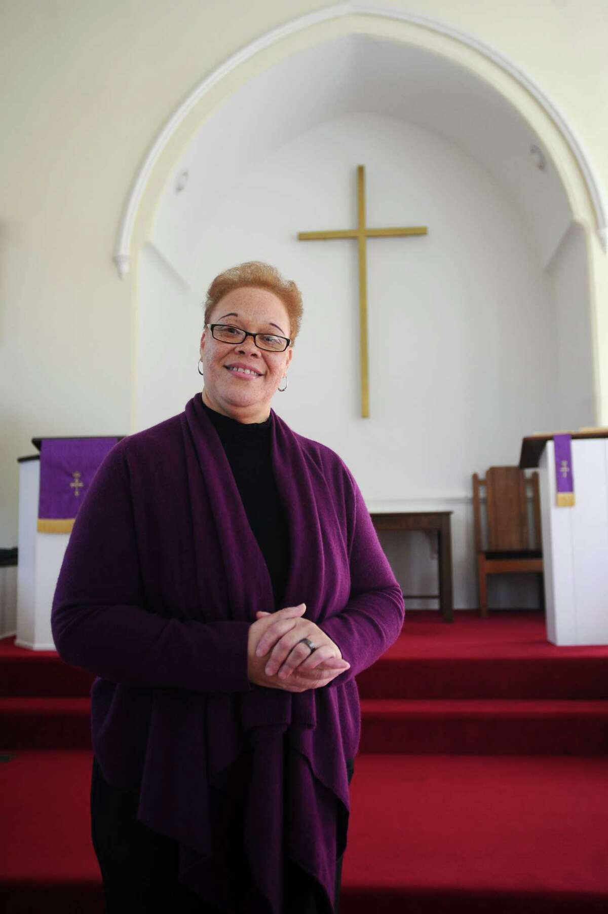 North Stamford Congretional Church Rev. Jacqueline Gilchrist poses for a photo inside her church on Thursday, Feb. 18, 2016. Rev. Gilchrist says she does not like to stand at the alter and preach, but instead gives a sermon while walking around interacting with her parishoners.