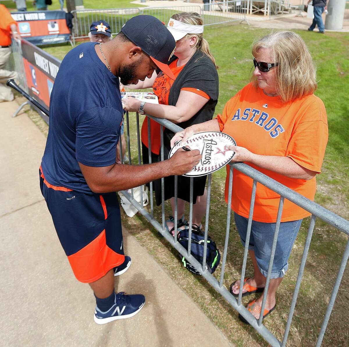 Houston Astros infielder Luis Valbuena signs an autograph for fan Carole Townsend as he walked back to the clubhouse after the batting cages during spring training in Kissimmee, Florida, Saturday, Feb. 20, 2016.