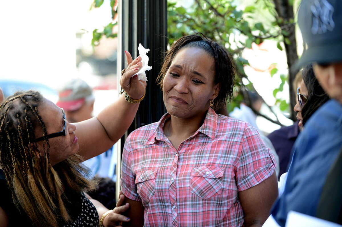 Aisha Dixon, the mother of Marquis Dixon, center, is comforted by her mother, Jackie, left, during a press conference and rally outside Albany District Attorney David Soares?’ office Monday, Aug. 10, 2015, in Albany, N.Y. Advocates called on the district attorney to publicly call the nine-year sentence teen Marquis Dixon received for stealing sneakers excessive and to support Raise the Age legislation that has awaits action by the state Legislature next year. They also called on him to finish an investigation into the police-related death of Donald ?“Dontay?” Ivy, deliver indictments against the three officers involved and publicly support the use of a special prosecutor in cases of police killings of civilians. (Will Waldron/Times Union)