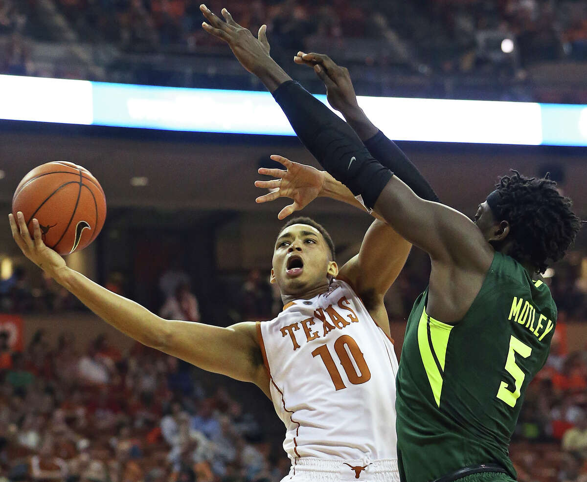 Longhorn guard Eric Davis challenges Bear forward Johnathan Motley at the hoop as UT hosts Baylor in men's basketball at the Erwin Center on February 20, 2016.