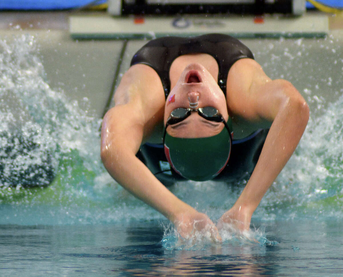 The Woodlands sophomore Lucie Nordmann leaves the blocks in her heat of the Girls 100 Yard Backstroke during the Conference 6A prelims at the 2016 UIL State Swimming and Diving Championships at the Texas Swim Center in Austin on Friday, Feb. 19, 2016. (Photo by Jerry Baker/Freelance)