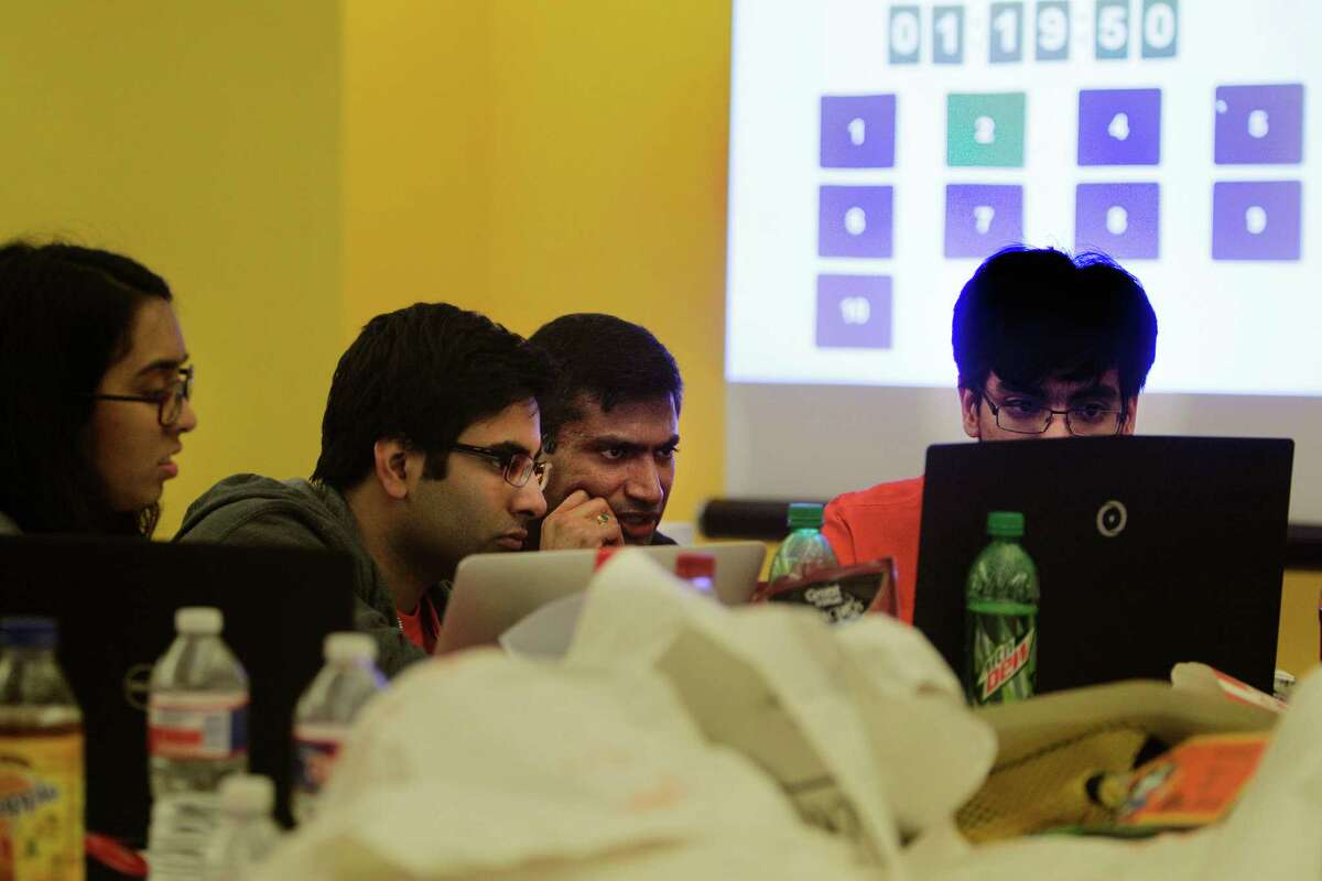 University of Texas-Dallas students Amber Hasan, Rupesh Pancholi, and Nikoli Cartagena worked to complete the challend with the help of J.P. Morgan Chase-Dallas' Hagosh Chalasani, second from right. attempt to finish in the Code for Good contest Saturday, Feb. 20, 2016, in Houston. Code for Good, the challenge brings together college students and bank employees who love technology and want to make a difference. These 24-hour events run overnight, with students coding in teams and racing against the clock -and each other - to come up with creative, technological solutions to solve real challenges faced by 2 local nonprofits. The non-profits are community partners of ours - Neighborhood Centers Inc. and the Children's Museum of Houston. ( Steve Gonzales / Houston Chronicle )
