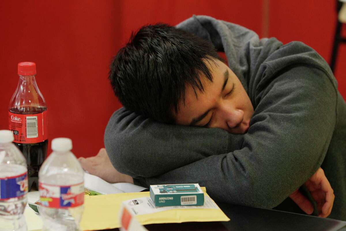 University of Houston student Michael Pham lost the battle to stay awake with an hour and half to go in the Code for Good contest. Saturday, Feb. 20, 2016, in Houston. Code for Good, the challenge brings together college students and bank employees who love technology and want to make a difference. These 24-hour events run overnight, with students coding in teams and racing against the clock -and each other - to come up with creative, technological solutions to solve real challenges faced by 2 local nonprofits. The non-profits are community partners of ours - Neighborhood Centers Inc. and the Children's Museum of Houston. ( Steve Gonzales / Houston Chronicle )