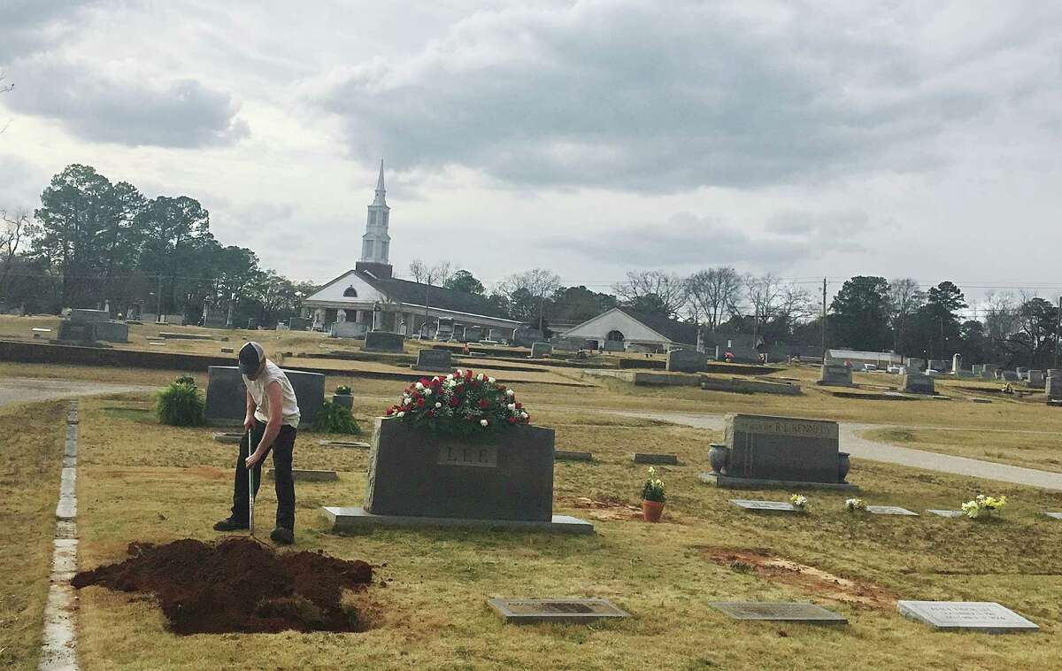 Lee family cemetery A man rakes dirt over a grave in the Lee family cemetery plot, Saturday, Feb. 20, 2016, in Monroeville, Ala. Harper Lee, the author of "To Kill a Mockingbird," died Feb. 19, 2016, at 89. 