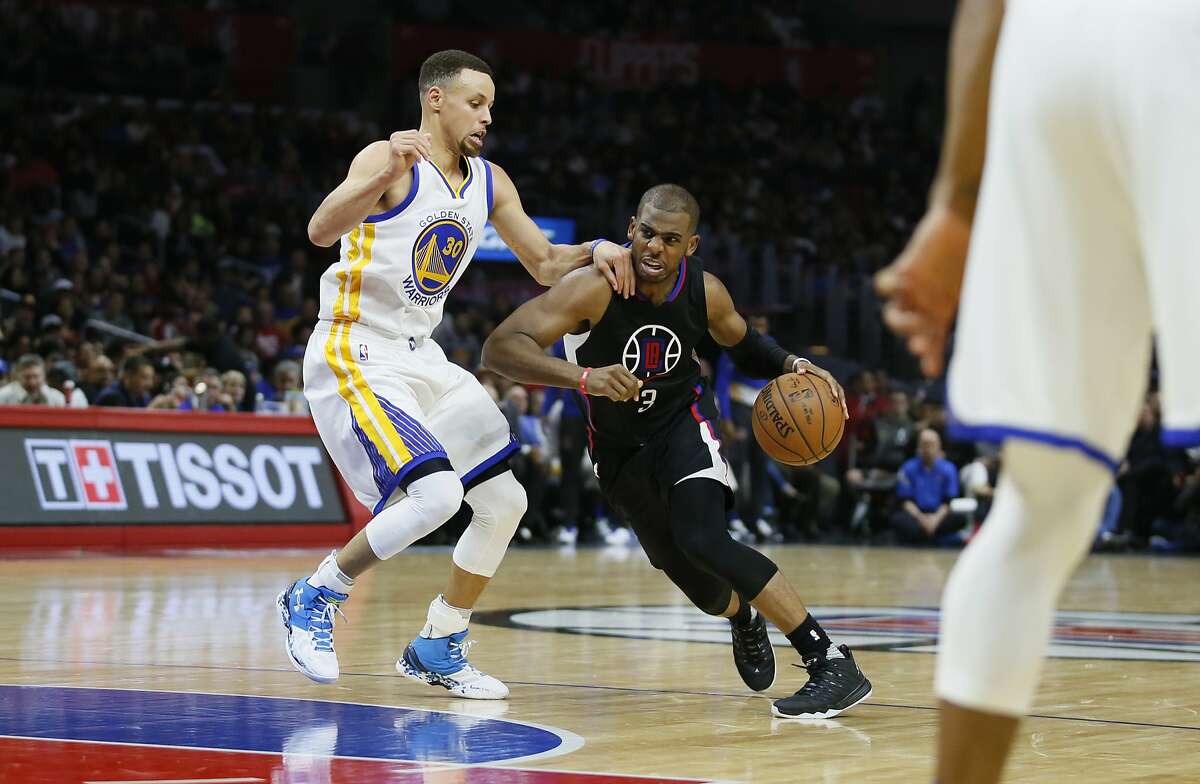 Chris Paul attempts to drive around Stephen Curry during the first half of an NBA basketball game, Saturday, Feb. 20, 2016, in Los Angeles.
