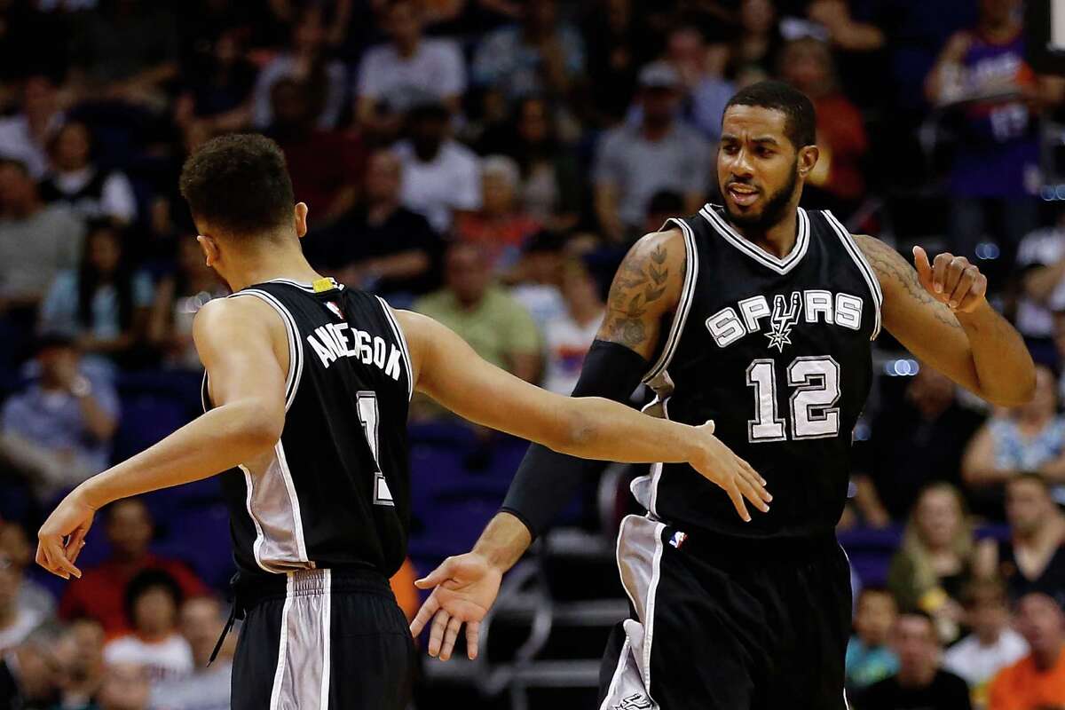 PHOENIX, AZ - FEBRUARY 21: LaMarcus Aldridge #12 of the San Antonio Spurs high fives Kyle Anderson #1 after scoring against the Phoenix Suns during the first half of the NBA game at Talking Stick Resort Arena on February 21, 2016 in Phoenix, Arizona. NOTE TO USER: User expressly acknowledges and agrees that, by downloading and or using this photograph, User is consenting to the terms and conditions of the Getty Images License Agreement.