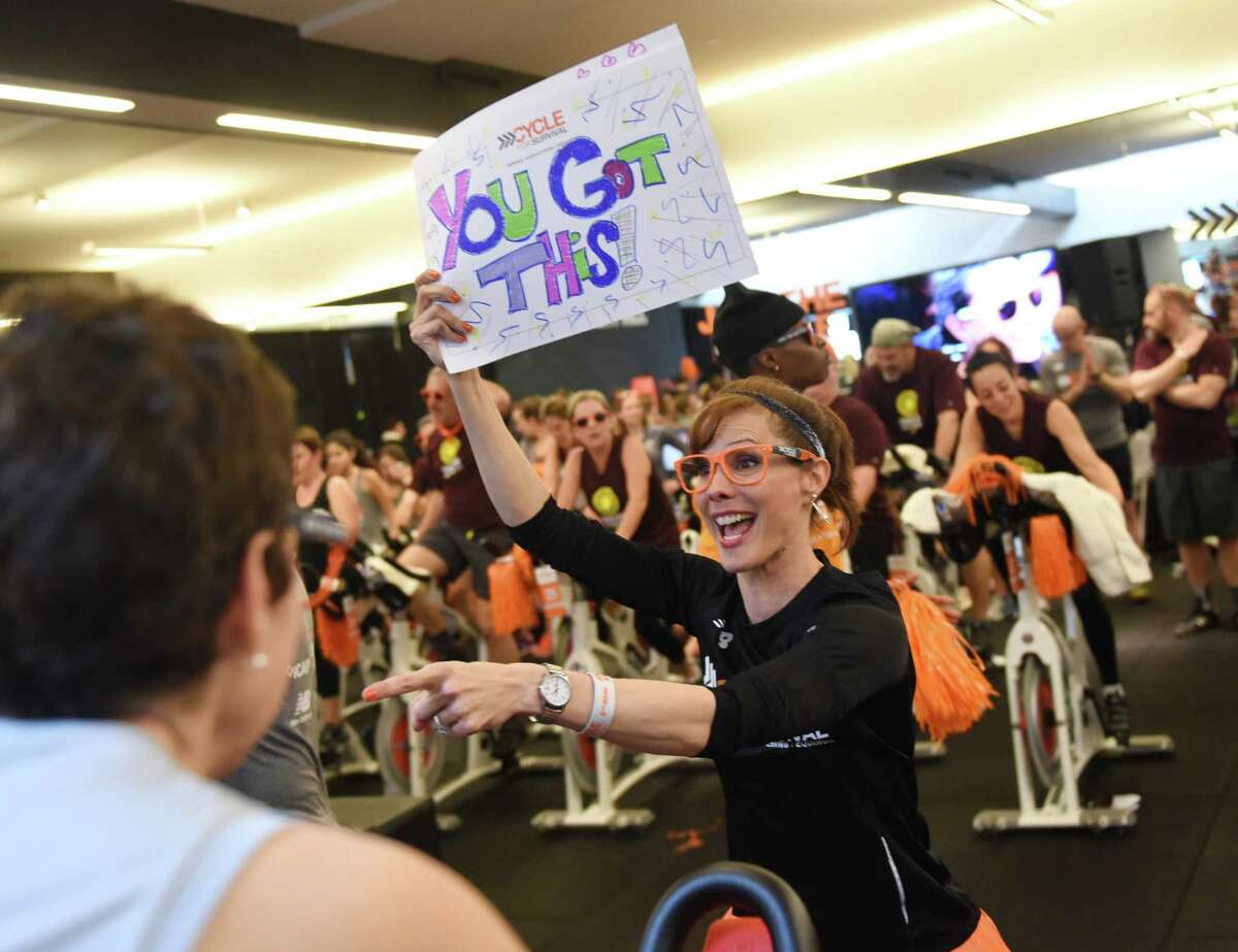 Event emcee Tracey Wilson pumps up the riders during the Cycle for Survival indoor cycling fundraiser at Equinox in Greenwich, Conn. Sunday, Feb. 21, 2016. Cycle for Survival, owned and operated by Memorial Sloan Kettering, is a fundraiser with the goal to beat rare cancers by raising money through a series of indoor cycling events across the country. 2016 marks the tenth year of rides and the event has raised over $90 million since 2007. More than 800 riders participated at the event in Greenwich Sunday and the Spiritual Riders team led the way raising more than $140,000 alone.