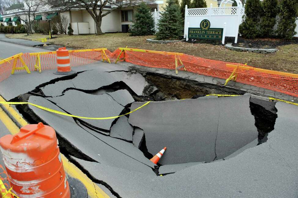 Troy road damaged after collapsed sewer line creates sinkhole