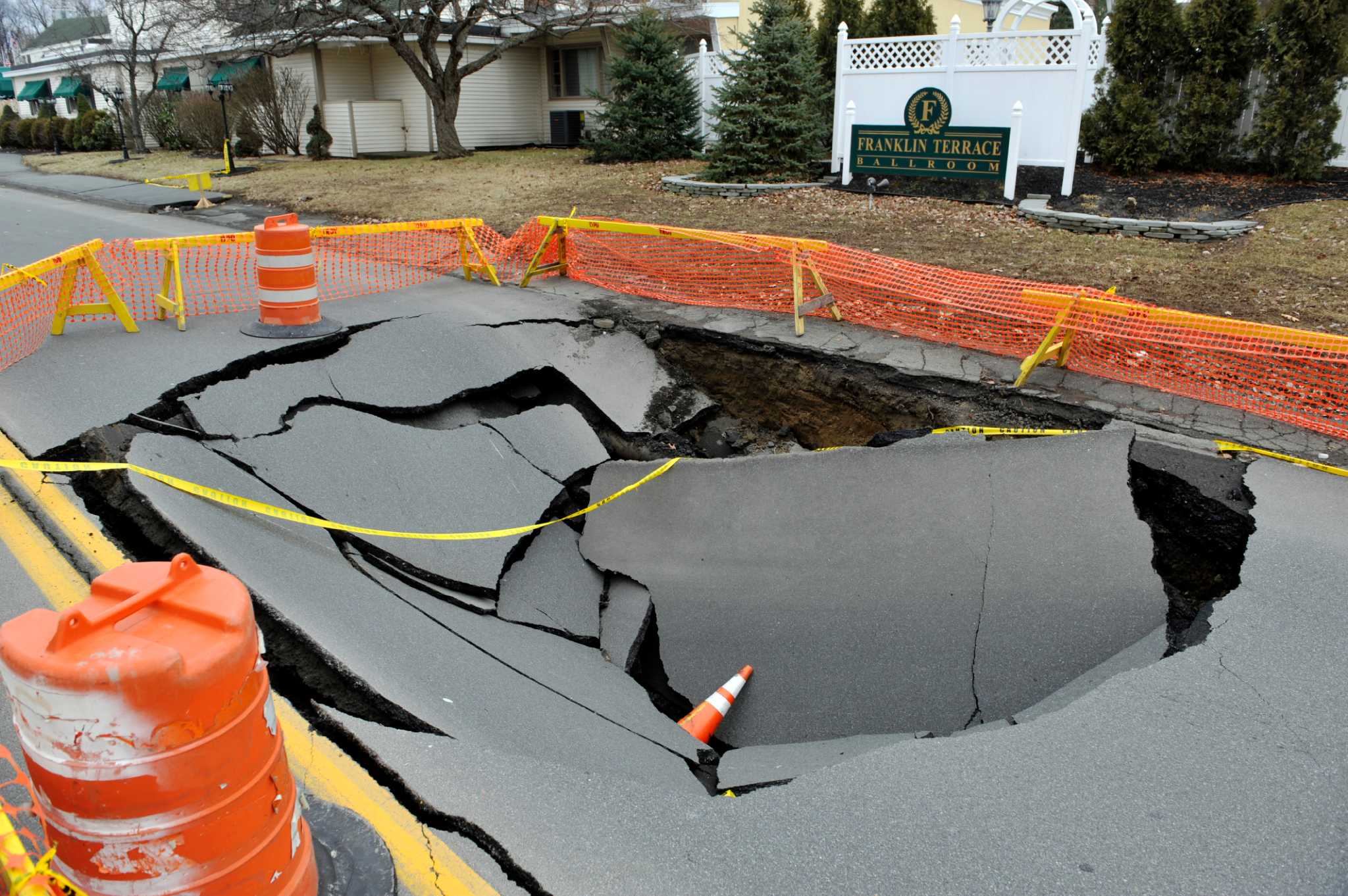 Troy road damaged after collapsed sewer line creates sinkhole