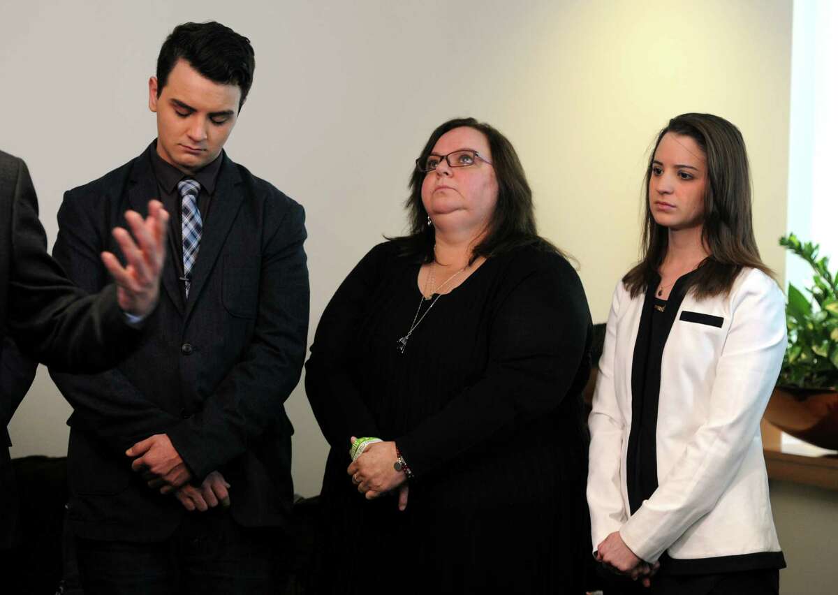 Carlos, Donna and Jillian Soto join other Sandy Hook families suing a gunmaker for providing the AR-15-type Bushmaster at a news conference at Koskoff, Koskoff & Bieder in Bridgeport on Monday. A state Superior Court judge will decide whether the lawsuit will be dismissed or progress to a jury trial.