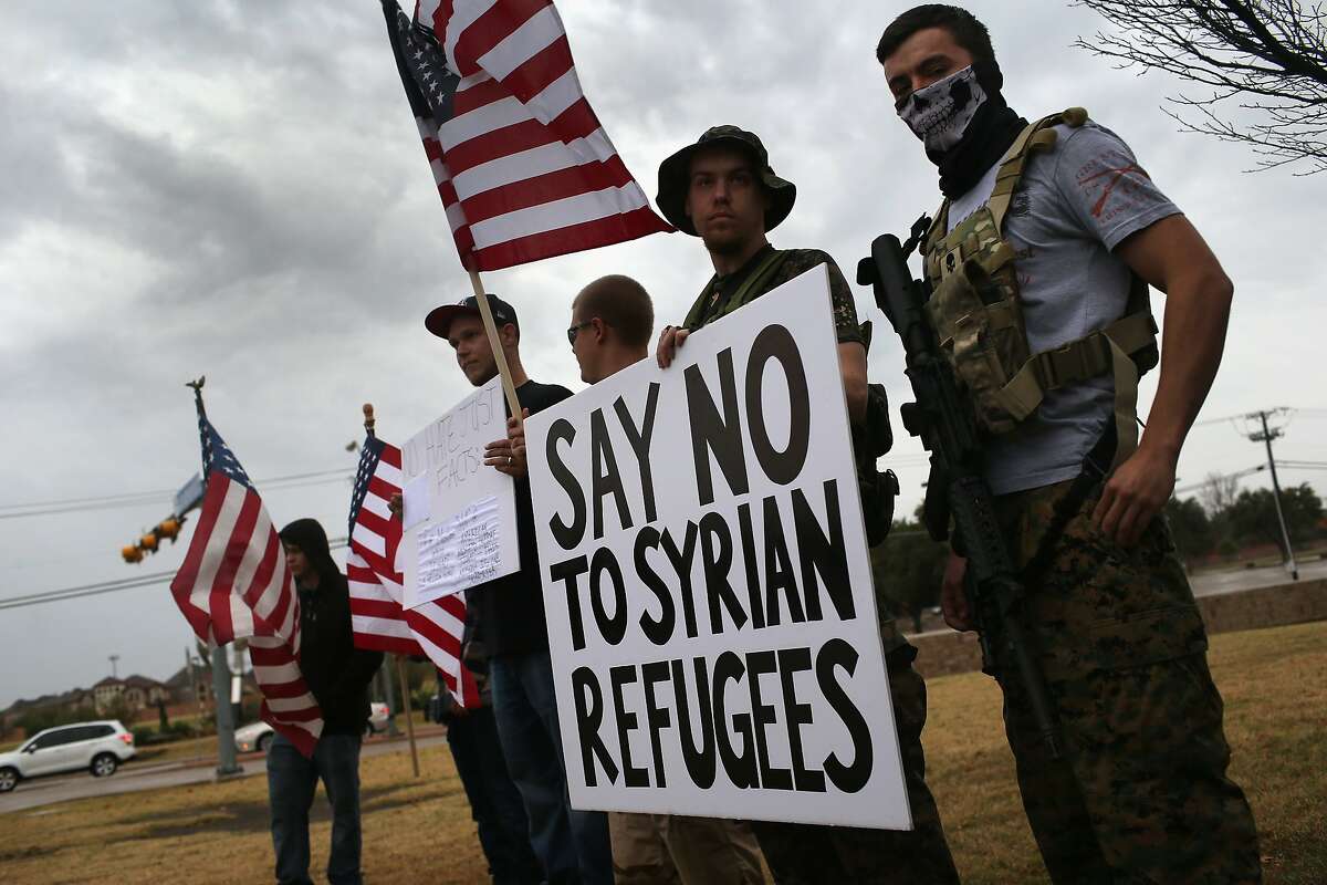 Armed protesters from the so-called Bureau of American-Islamic Relations (BAIR), take part in a demonstration in front of a mosque on December 12, 2015 in Richardson, Texas.