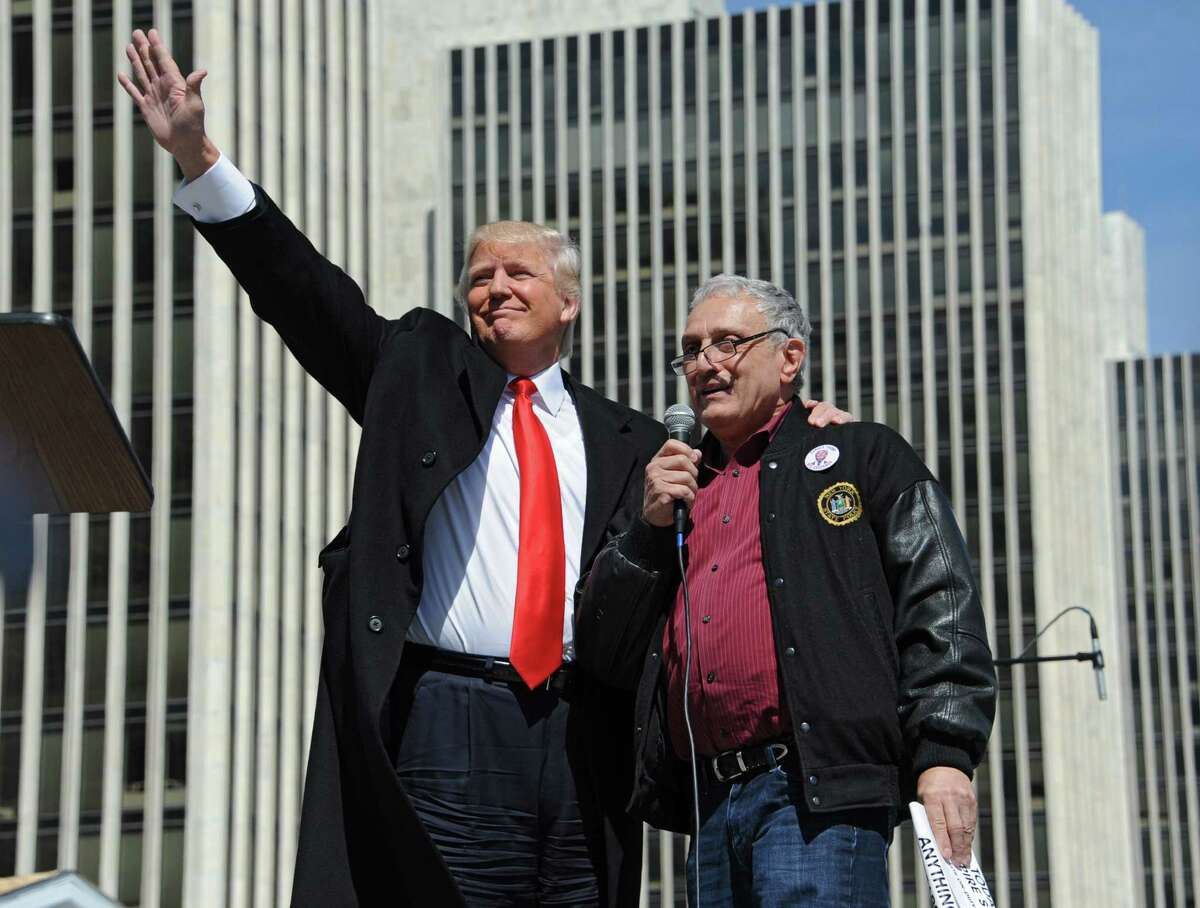 Donald Trump, left, stands with Carl Paladino, businessman and political activist from Buffalo, after he spoke to a crowd of Second Amendment advocates rallying against the NY SAFE Act at the Empire State Plaza Tuesday, April 1, 2014, in Albany, N.Y. State Board of Elections records show Trump has since the beginning of 2000 given more than $640,000 to candidates for local and state office. (Lori Van Buren / Times Union)