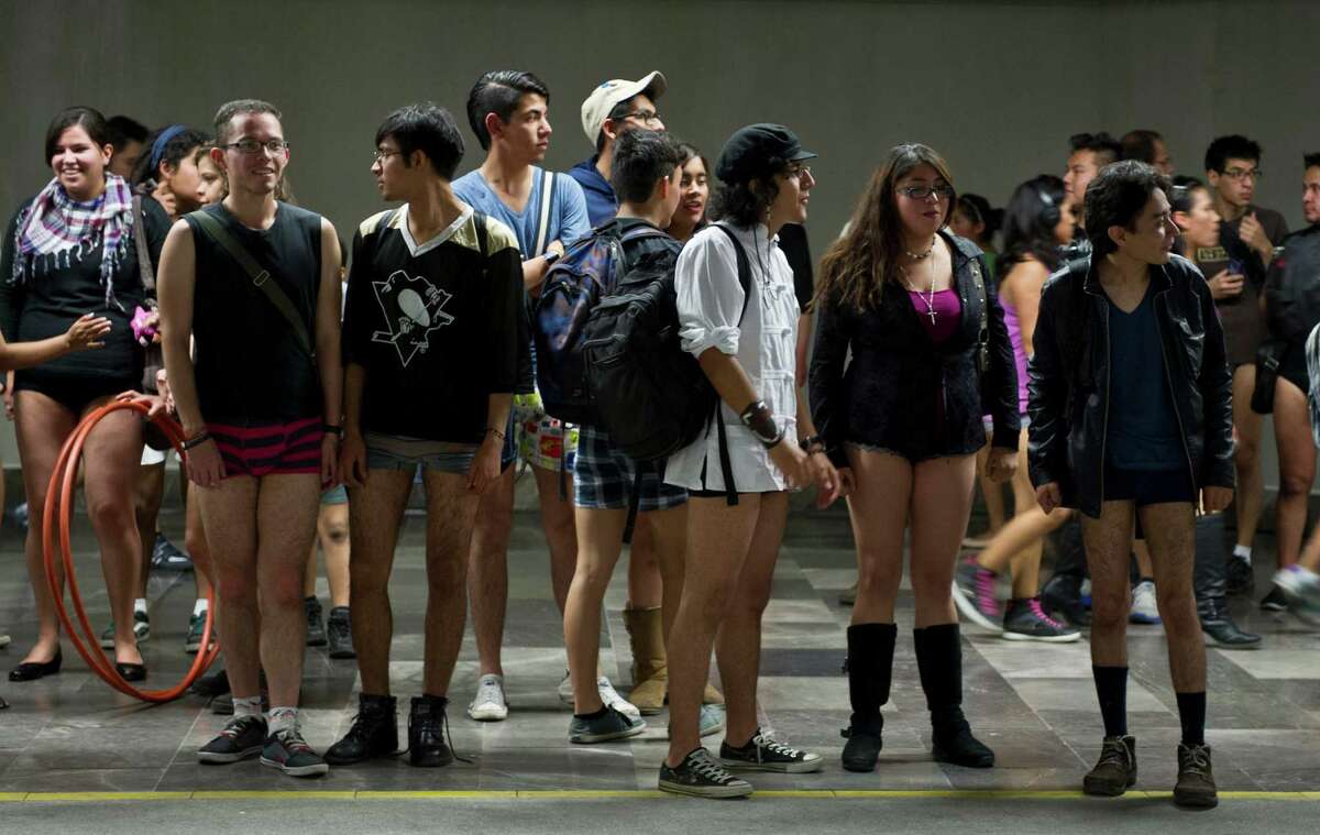 People wait for the train at a subway station during the worldwide 'No Pants Subway Ride' event in Mexico City on January 13, 2013. The 'No Pants Subway Ride', though in its 12th year, still surprises fellow passengers on public transit, and is spreading to other cities across the globe. AFP PHOTO/RONALDO SCHEMIDT