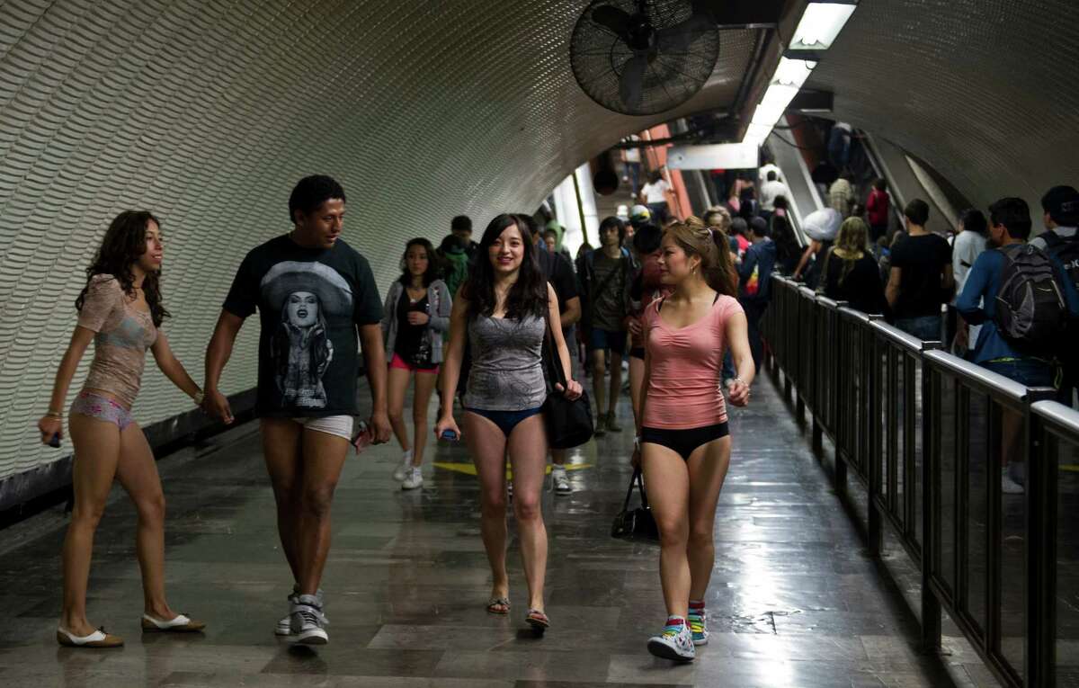 People walk through a subway station during the worldwide 'No Pants Subway Ride' event in Mexico City on January 13, 2013. The 'No Pants Subway Ride', though in its 12th year, still surprises fellow passengers on public transit, and is spreading to other cities across the globe. AFP PHOTO/RONALDO SCHEMIDT