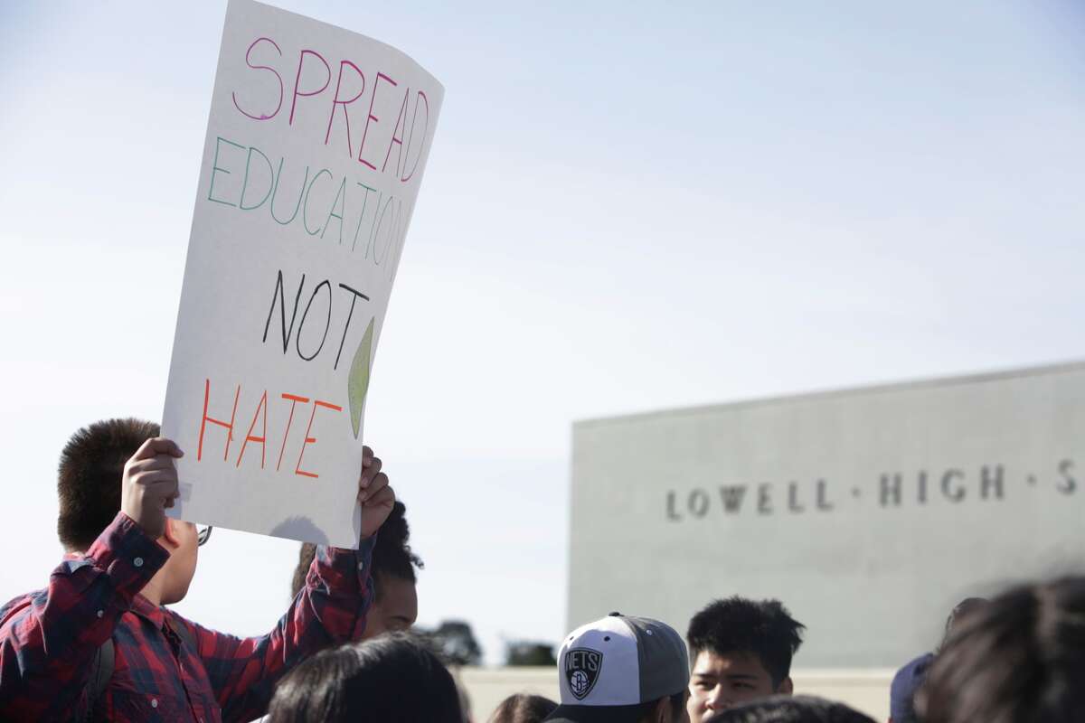 Lowell High School student Johnny Hall, senior, 17, holds a sign in front of Lowell High School during a walk out with other students to protest the response to a poster hung on a library door referring negatively to black students and Black History Month on Tuesday, February 23, 2016 in San Francisco, California.